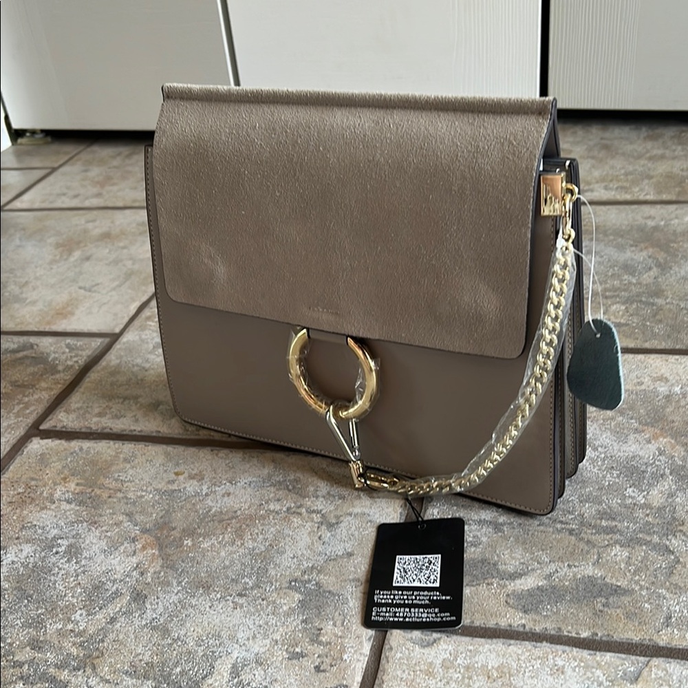 Gray Shoulder Bag with Gold Accent and Flap Closure